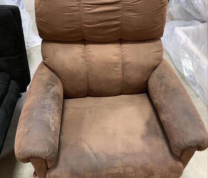 Brown recliner with brown stains on arms and middle 