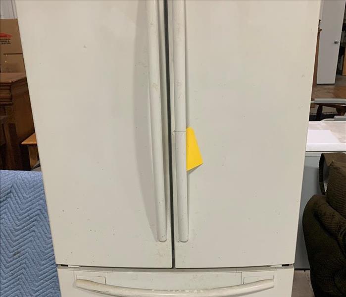 Dust covered white refrigerator 